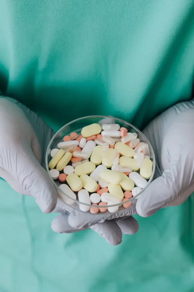 Nurse holding a tray of multiple pills representing a need for medication management