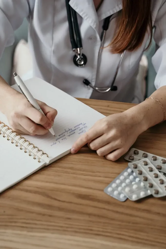 Physician writing a prescription for medication management in Orange County, California