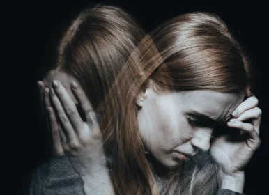 Bipolar Disorder Test and Guide at Socal Mental Health: woman having a bipolar manic episode; left side image of her with her hands covering her face, and right side she is looking down with a sad and distressed look with a hand on her forehead